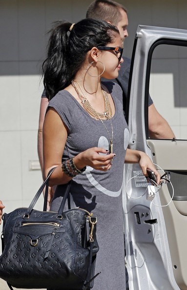 Gomez with Louis Vuitton Empreinte Bag