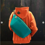 Chanel Pharrell Turquoise Belt Bag and Orange Hoodie